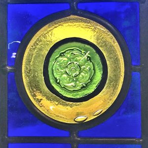recycled glass flowers in circles stained glass panel blue background