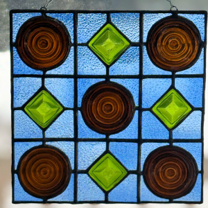 Stained glass window panel made from beer bottle bottoms