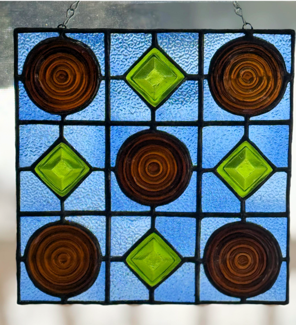 Stained glass window panel made from beer bottle bottoms