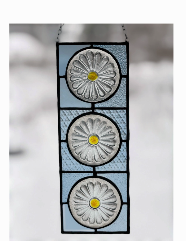 stained glass window panel featuring 3 clear daisies with pinnacle vodka glass background