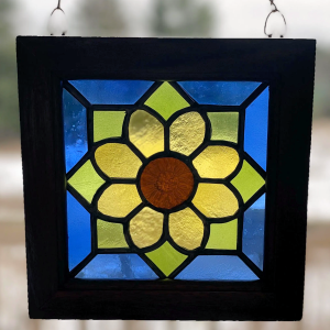 stained glass panel featuring a flower design in recycled glass