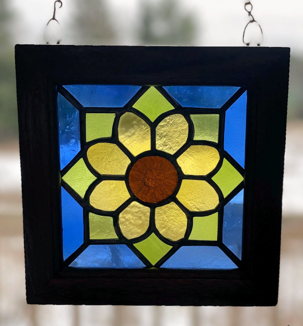 stained glass panel featuring a flower design in recycled glass